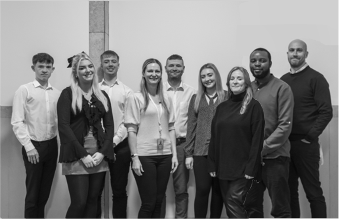 Group of people stood smiling