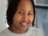 A headshot of a smiling female