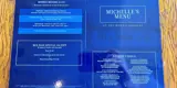 A food menu from the Morris Dancers pub in Bolton. The menu page is blue and shows special offers including pensioners deals and daily special deals