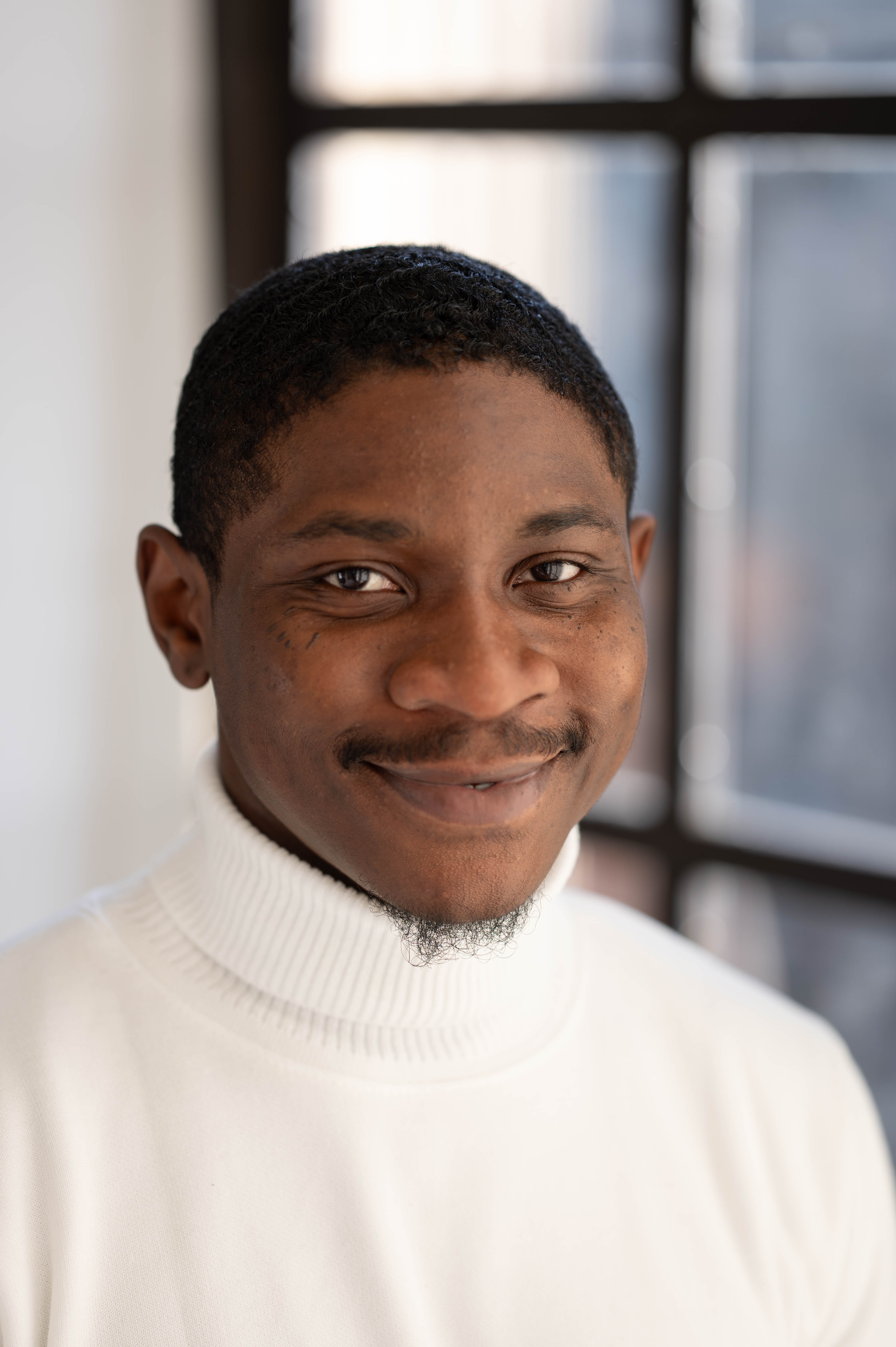 A headshot of a man smiling at the camera