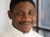 A headshot of a man smiling at the camera.