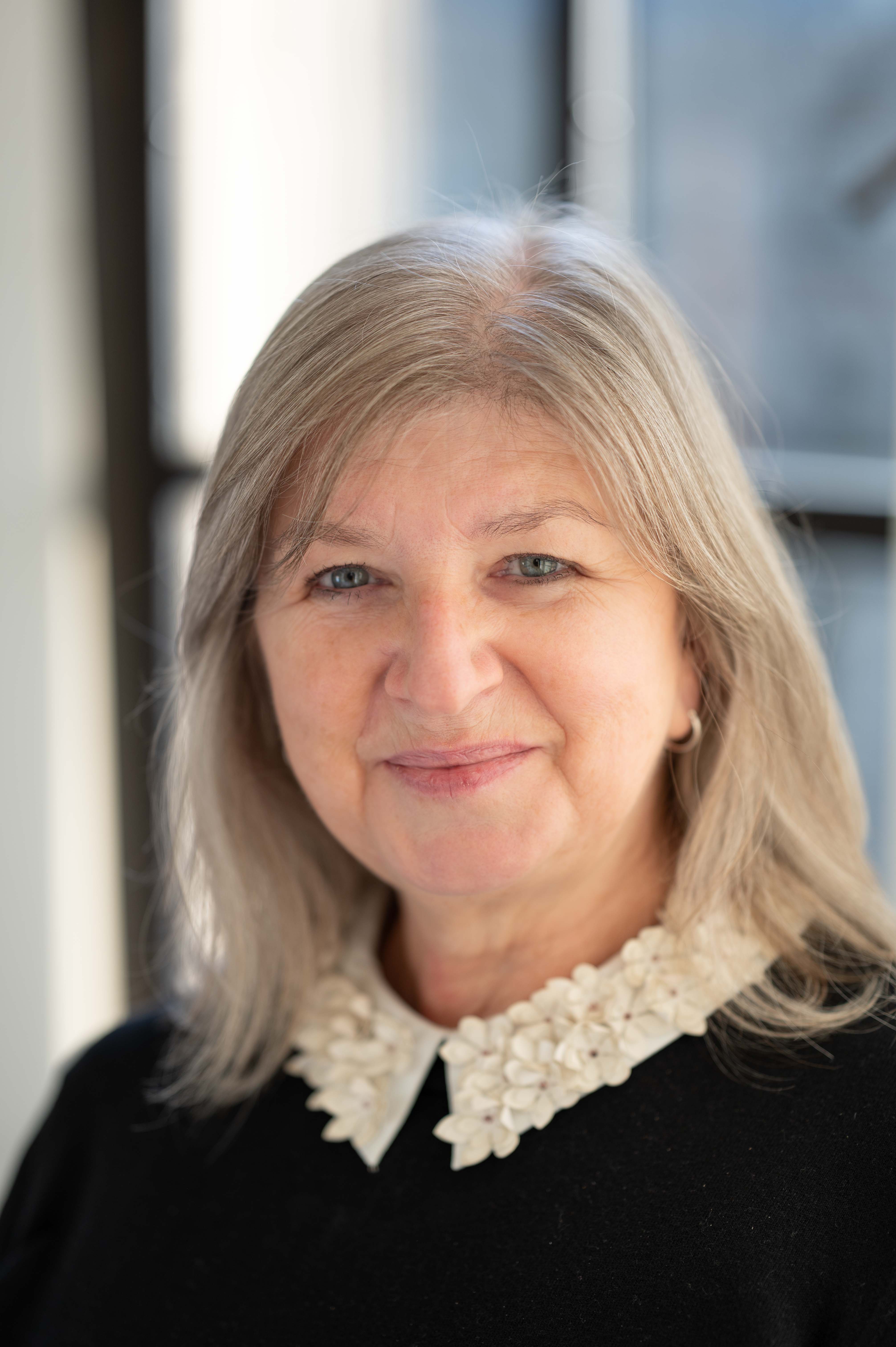 A headshot of a lady smiling at the camera