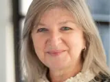 A headshot of a smiling female