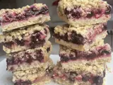 Two stacks of flapjacks with a blueberry layer