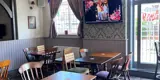 Tables and chairs in the dining area of the Morris Dancers pub in Bolton