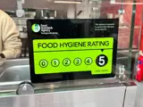 An image of a 5 Food Hygiene Rating sticker on the front of a glass counter