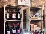 An image of wines and beers on wooden crate style shelves