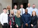 The business compliance support team posing for a group photograph.
